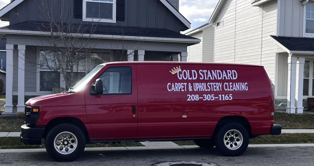 Gold Standard red service van parked outside a Boise home for a carpet cleaning appointment.