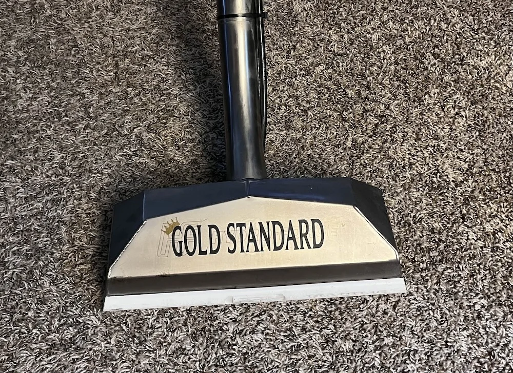 Branded Gold Standard carpet cleaning wand removing dirt from high-pile carpet